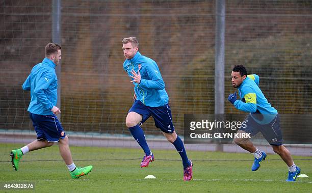 Arsenal's German defender Per Mertesacker , French midfielder Francis Coquelin and English defender Calum Chambers attend a training session at...