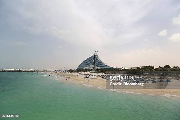 Holidaymakers occupy the beach near the Jumeirah Beach hotel in Dubai, United Arab Emirates, on Saturday, Nov. 8, 2014. A year ago, Dubai regulators...