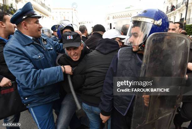 Algerian protesters scuffle with security forces during a demonstration called by associations and opposition parties against the exploitation of...