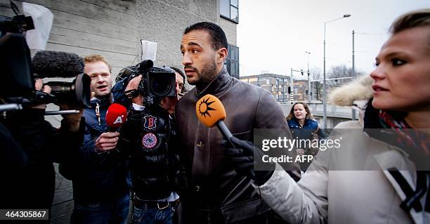 Former K-1 heavyweight kick-boxing champion Badr Hari talks to the press as he arrives at the Amsterdam courtroom on 22 January 2014. Hari faces...