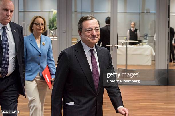 Mario Draghi, president of the European Central Bank , center, arrives to unveil a new twenty euro banknote at the ECB headquarters in Frankfurt,...