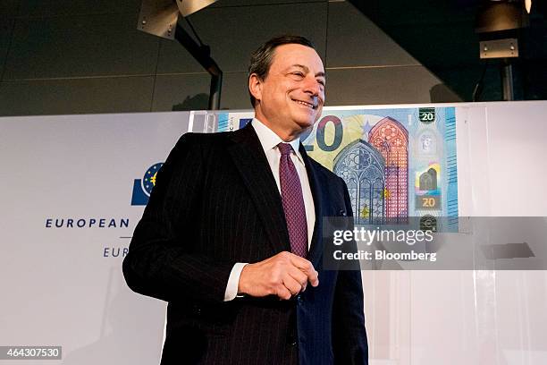 Mario Draghi, president of the European Central Bank , reacts as he unveils a new twenty euro banknote at the ECB headquarters in Frankfurt, Germany,...