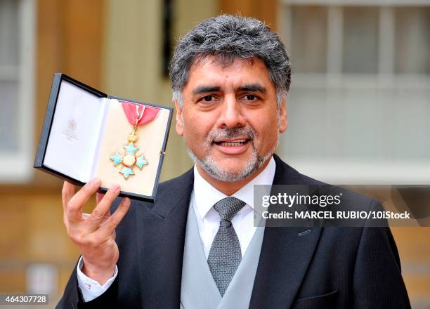 British founder and chairman James Caan holds his Commander of the Order of the British Empire medal presented to him by the Duke of Cambridge for...