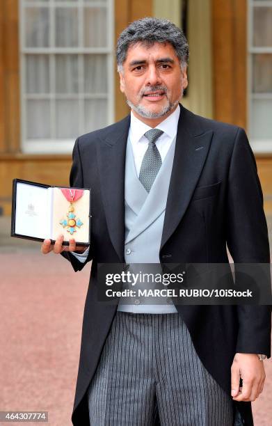 British founder and chairman James Caan holds his Commander of the Order of the British Empire medal presented to him by the Duke of Cambridge for...