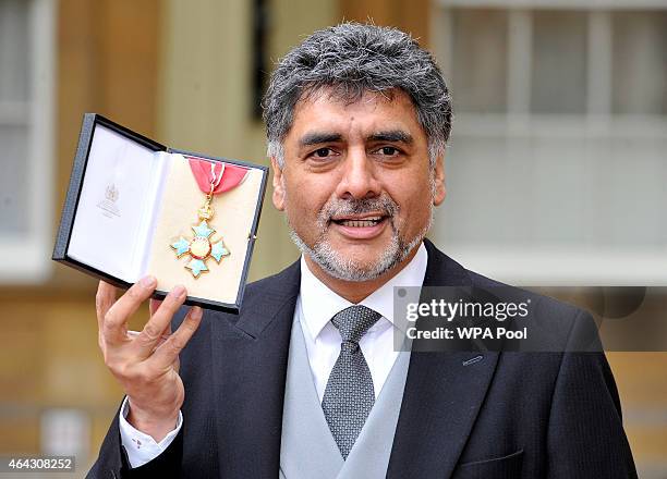 Businessman James Caan holds his Commander of the Order of the British Empire medal presented to him by the Duke of Cambridge for services to...