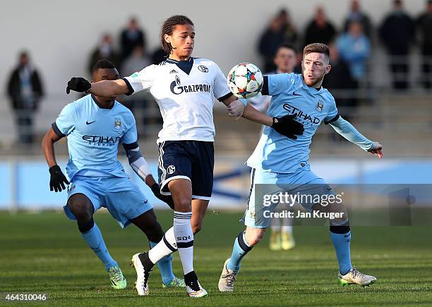 Leroy Sane of FC Schalke 04 battles with Jack Byrne of Manchester City FC during the UEFA Youth League Round of 16 match between Manchester City FC...