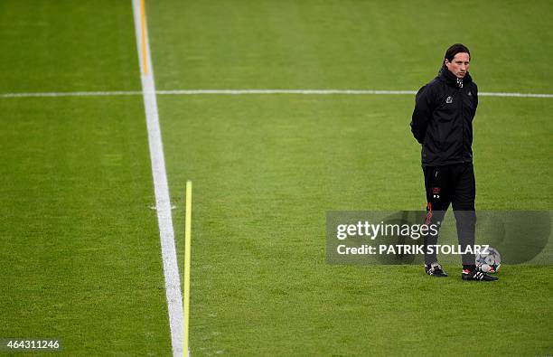 Leverkusen's head coach Roger Schmidt oversees a training session on the eve of the UEFA Champions League first-leg, round of 16 football match Bayer...