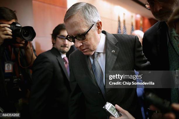 Senate Minority Leader Harry Reid leaves a news conference where he accused Republican Senate leaders of manufacturing the possible shutdown of the...