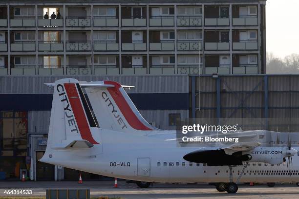 The tail fins of Avro RJ85, right, and Fokker 50 passenger aircraft, operated by CityJet Ltd., a unit of Air France-KLM Group, stand on the tarmac as...