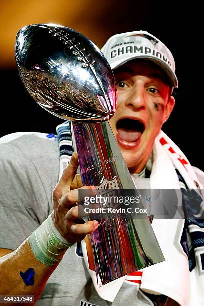 Rob Gronkowski of the New England Patriots celebrates while holding up the Vince Lombardi Trophy after defeating the Seattle Seahawks during Super...