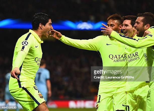 Luis Suarez of Barcelona celebrates scoring their second goal with team mates during the UEFA Champions League Round of 16 match between Manchester...