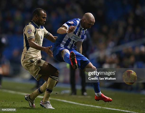 Bruno Saltor of Brighton & Hove Albion is tackled by Rodolph Austin of Leeds during the Sky Bet Championship match between Brighton & Hove Albion and...