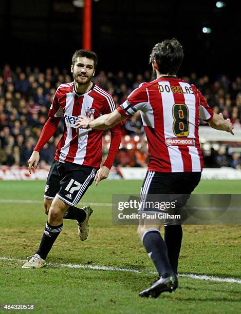 Jon-Miquel Toral of Brentford is congratulated by teammate Jonathan Douglas of Brentford after scoring the opening goal during the Sky Bet...