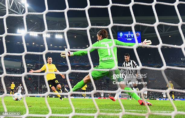 Alvaro Morata of Juventus scores their second goal past goalkeeper Roman Weidenfeller of Borussia Dortmund during the UEFA Champions League Round of...