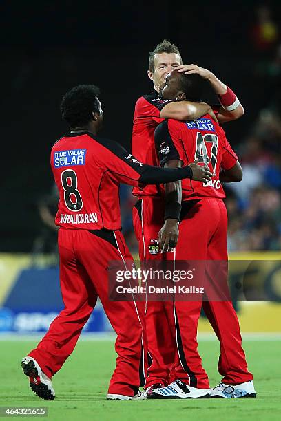 Muthiah Muralidaran, Peter Siddle and Dwayne Bravo of the Renegades celebrate victory during the Big Bash League match between the Adelaide Strikers...