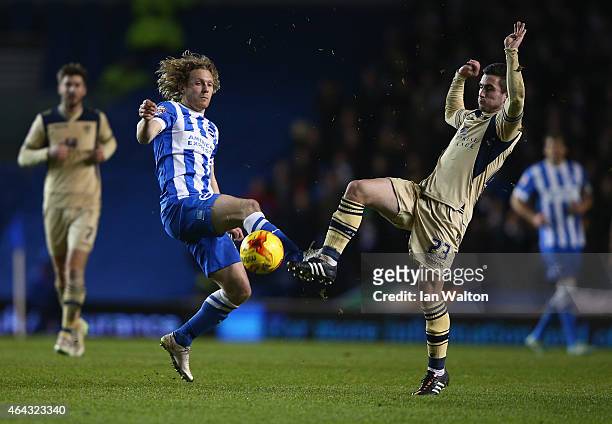 Craig Mackail-Smith of Brighton & Hove Albion and Lewis Cook of Leeds in action during the Sky Bet Championship match between Brighton & Hove Albion...