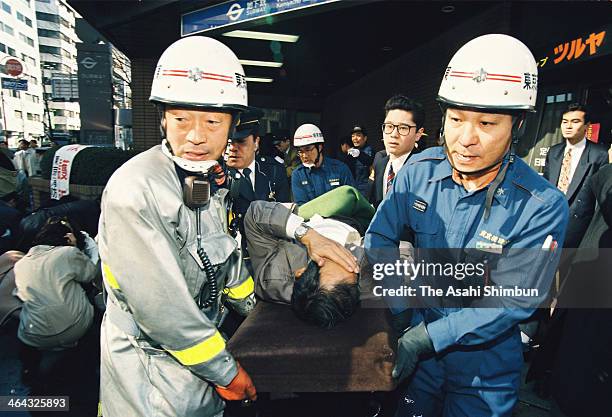 Fire fighters carry a sarin gas victim from Kamiyacho station on March 20, 1995 in Tokyo, Japan. The multiple chemical terrorist attack by Japanese...