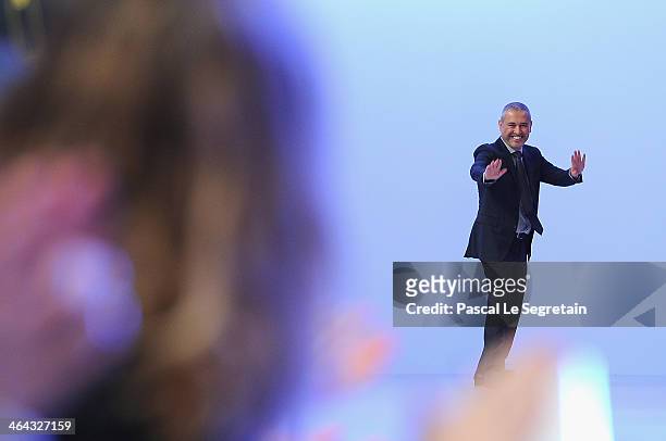 Fashion designer Elie Saab acknowledges the applause of the audience after his show as part of Paris Fashion Week Haute Couture Spring/Summer 2014 on...