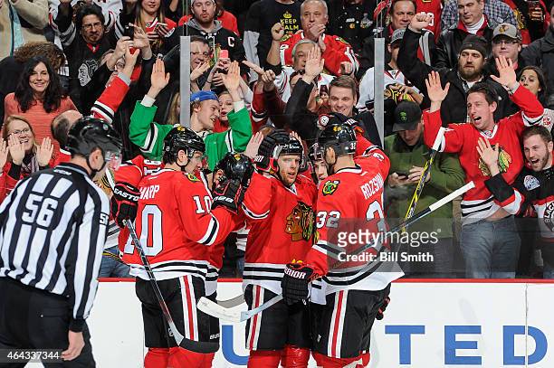 Kris Versteeg of the Chicago Blackhawks celebrates with teammates after scoring against the Florida Panthers in the second period of the NHL game at...