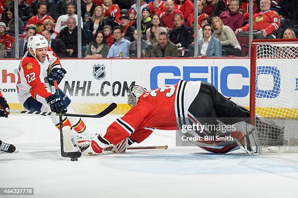 Shawn Thornton of the Florida Panthers attempts to score on goalie Scott Darling of the Chicago Blackhawks during the NHL game at the United Center...