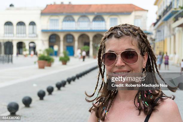 Tourist gets her hair done in the old cobblestone streets of the city. Old Havana is a UNESCO World Heritage Site and a major tourist landmark in...