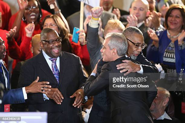 Chicago Mayor Rahm Emanuel gets a hug from Congressman Bobby Rush as he arrives on stage to greet supporters at an election night rally February 24,...
