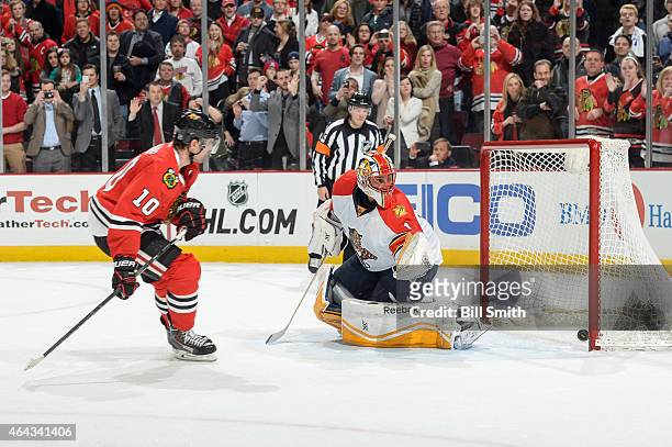 Patrick Sharp of the Chicago Blackhawks scores on the shoot-out against Roberto Luongo of the Florida Panthers during the NHL game at the United...