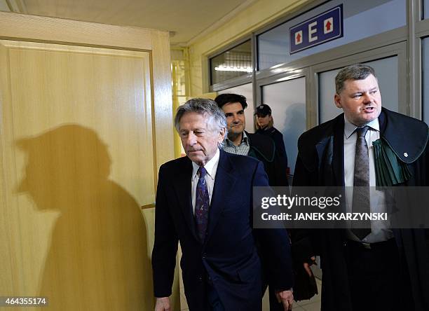 French-Polish film director Roman Polanski is accompanied by his lawyers as he arrives for a hearing at the regional court in Krakow on February 25,...