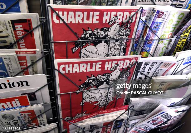 The latest edition of French satirical weekly newspaper Charlie Hebdo is on display at a newsstand on February 25, 2015 in Montpellier. More than a...