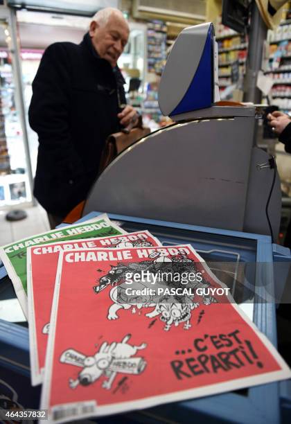 Man buys the latest edition of French satirical weekly newspaper Charlie Hebdo at a newstand in Montpellier on February 25, 2015. More than a month...