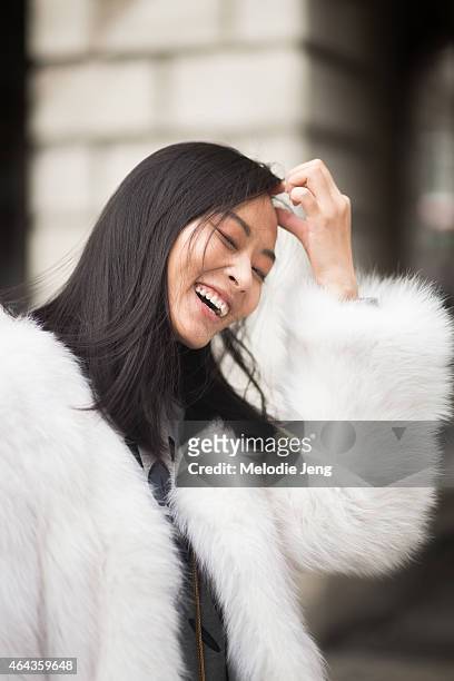 Model Li Xiao Xing exits the Emilio De La Morena show in vintage fur jacket, Kenzo sweater, Acne jeans, Saint laurent purse , Givenchy bag , and...