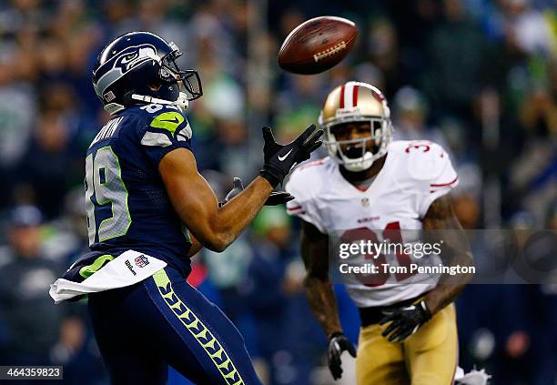 Wide receiver Doug Baldwin of the Seattle Seahawks catches the ball as strong safety Donte Whitner of the San Francisco 49ers defends during the 2014...