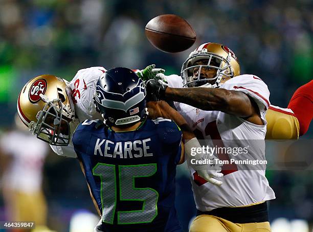 Wide receiver Jermaine Kearse of the Seattle Seahawks tries to make a catch as strong safety Donte Whitner and free safety Eric Reid of the San...