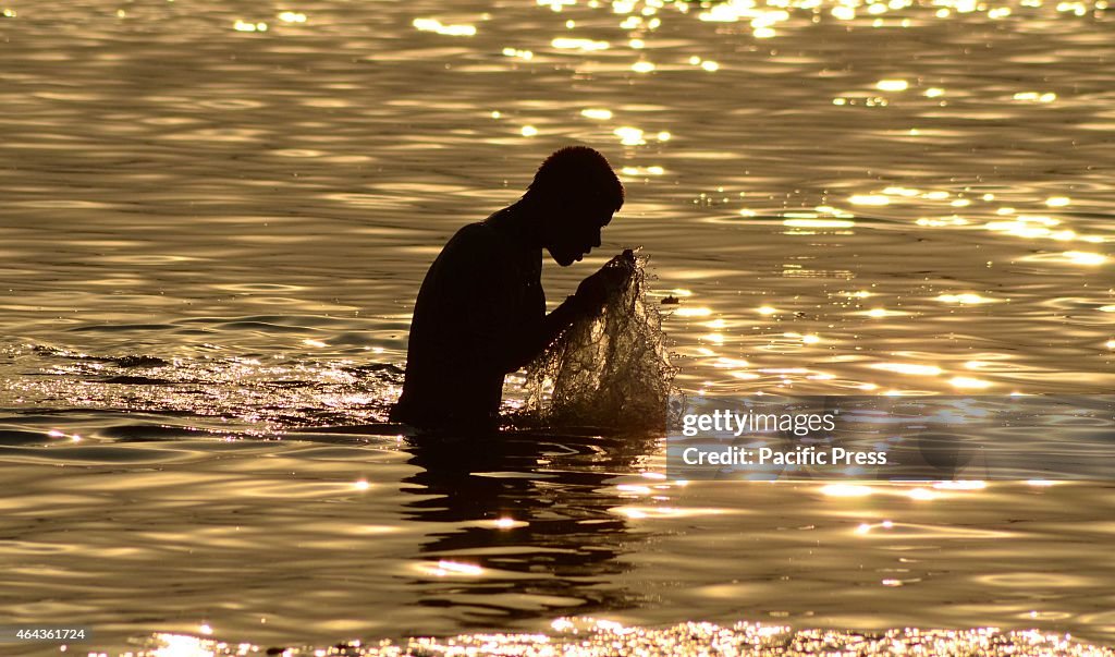 A devotee taking holydip during sunset at Sangam...