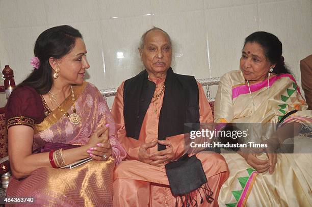 Bollywood actor Hema Malini, playback singer Asha Bhosle and classical singer Pandit Jasraj during the launch of Shri Hari Vani Gita album by Veena...