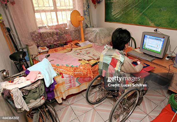 May 07: Li Yan sits in front of her computer in her home on May 7, 2007 in Yinchuan, Ningxia Province, China. Li Yan spends up to 10 hours per day in...