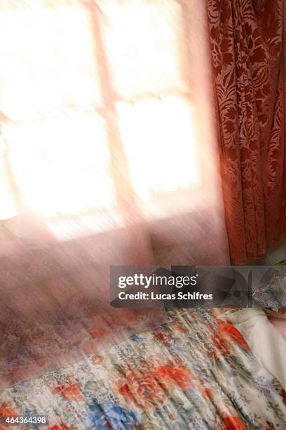 May 07: A ray of light hits Li Yan's bed that she shares with her mother in their home on May 7, 2007 in Yinchuan, Ningxia Province, China....