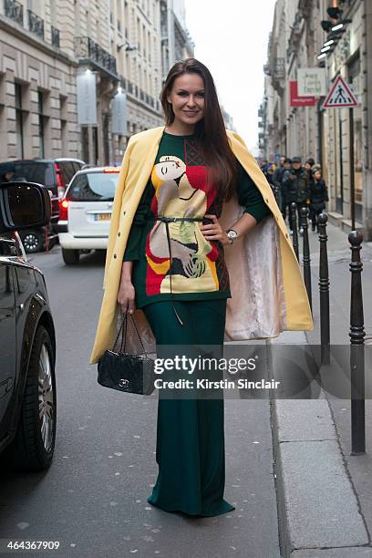 Presenter Yulia Kolyadixia wears a Libelolas dress, Prada sweater and Chanel bag day 2 of Paris Haute Couture Fashion Week Spring/Summer 2014, on...