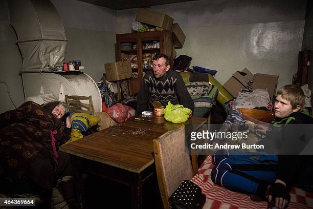 Igor Jakoulevna pauses while eating lunch with his family in the basement of an administrative building, where people have been living since August...