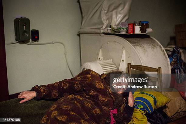 Nadegda Jakoulevna lies on a cot in the basement of an administrative building, where people have been living since August due to continued fighting,...
