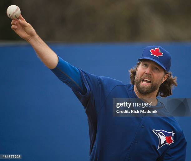 Pitcher RA Dickey works the bullpen with catcher Russell Martin. The team worked out at the Bobby Mattock Training Facility in Dunedin as the Jays...