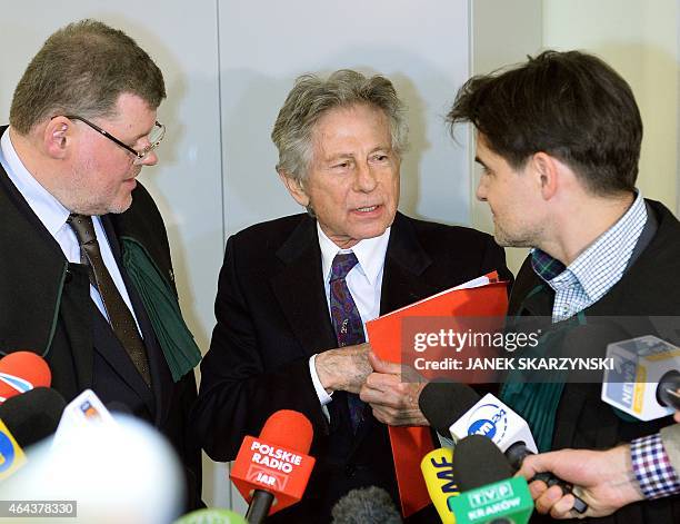 French-Polish film director Roman Polanski speaks with his lawers as he leaves the court after 9 hours hearing at the regional court in Krakow on...