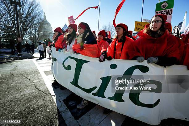 Pro-life activists participate in the annual March for Life as they march up the Capitol Hill on Constitution Avenue January 22, 2014 in Washington,...