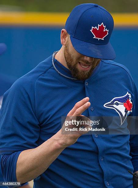 Pitcher Steve Delabar checks out his fingers during the warm up at the Bobby Mattock Training Facility in Dunedin as the Jays continue spring...