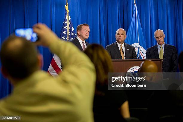 Jeh Johnson, U.S. Secretary of Homeland Security , center, listens to a question during a news conference with former secretaries of Homeland...