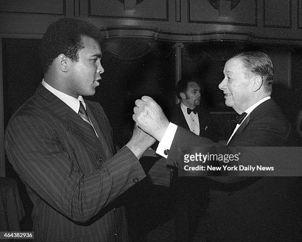 Heavyweight champ Cassius Clay squares off with fight buff Toots Shor during light moment at Hilton Hotel. Shor was honored with dinner by his...