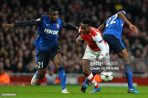 Monaco's French midfielder Geoffrey Kondogbia and Monaco's Nigerian defender Echiejile Elderson challenge Arsenal's English striker Danny Welbeck...