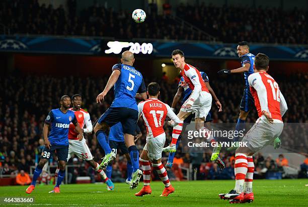 Arsenal's French defender Laurent Koscielny heads the ball during the UEFA Champions League round of 16 first leg football match between Arsenal and...
