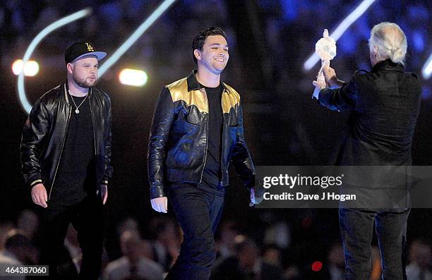 Jimmy Page presents Best British Group award to Royal Blood on stage at the BRIT Awards 2015 at The O2 Arena on February 25, 2015 in London, England.