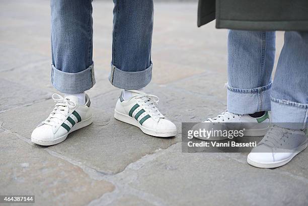 Guests poses wearing Adidas Superstar and Adidas Stan Smith shoes on February 25, 2015 in Milan, Italy.